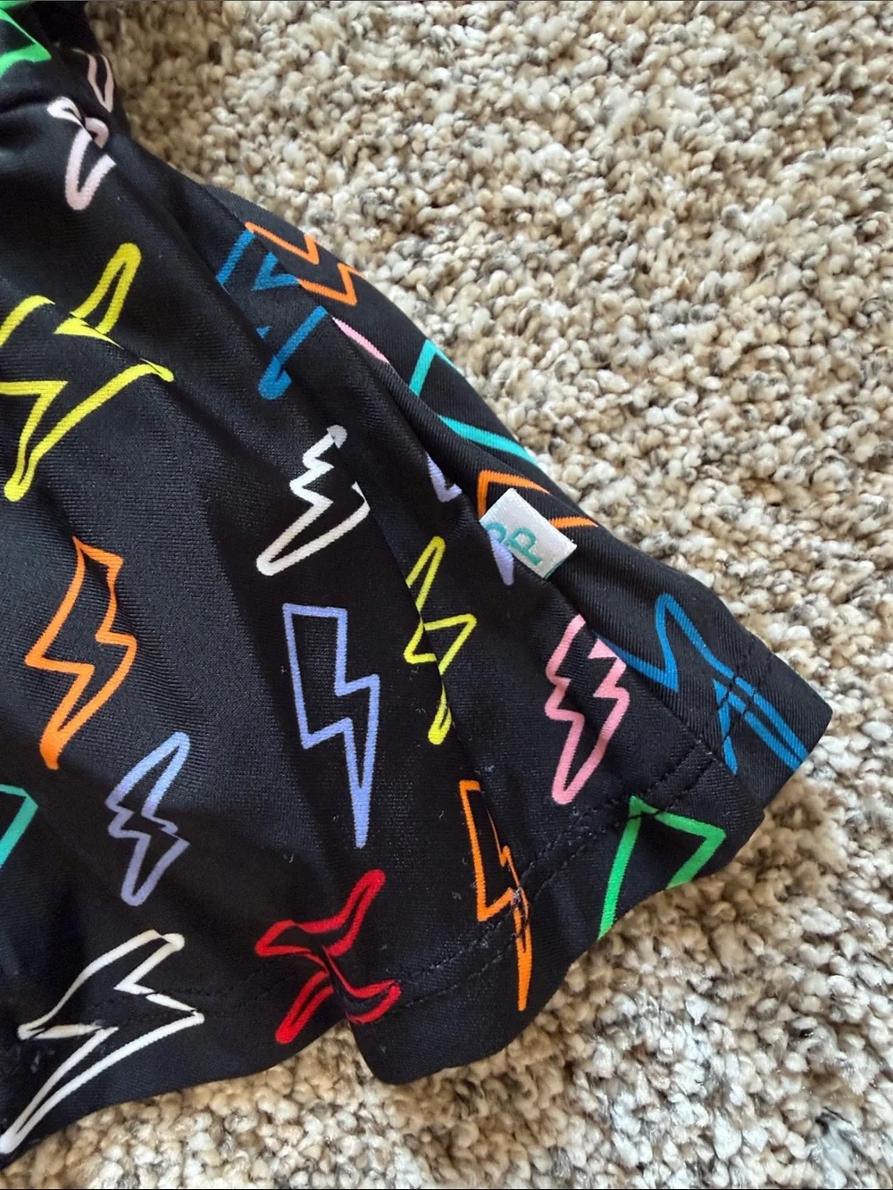 Posh Peanut Black Lightning Bolt Peplum Swimsuit with Multicolor Bolts